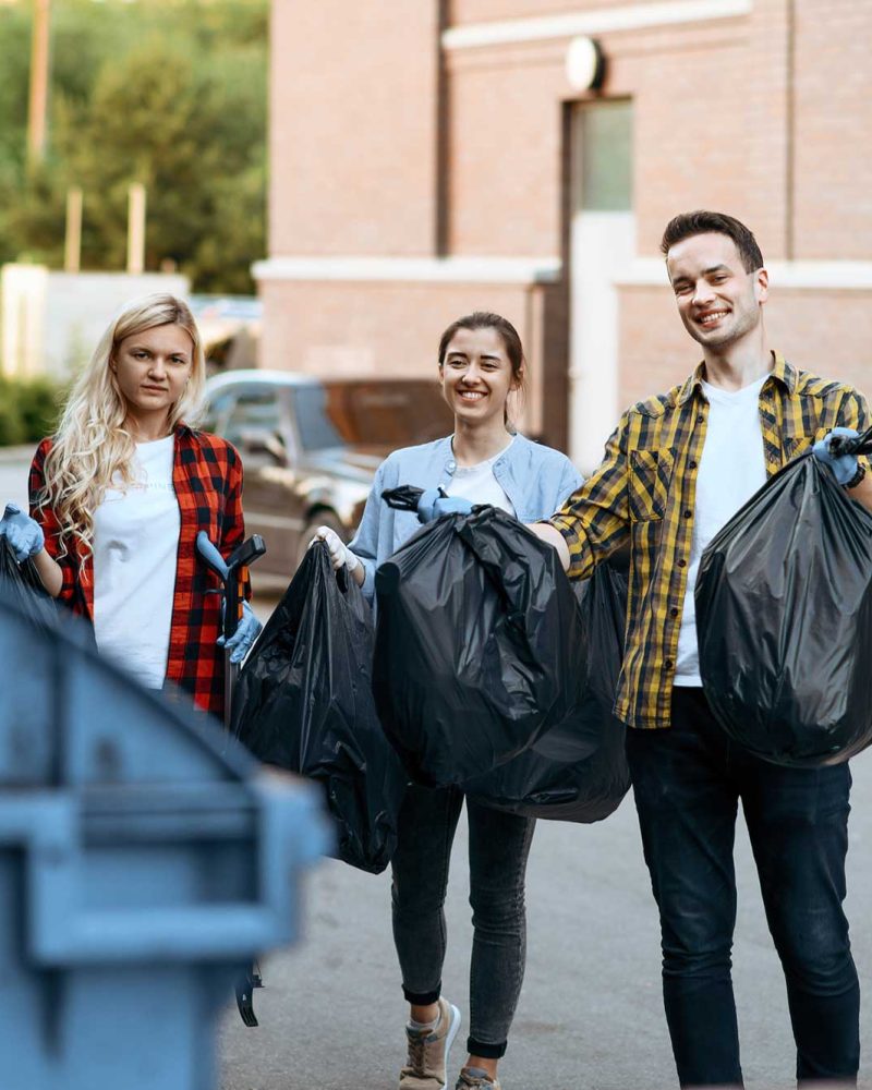 volunteers-holds-plastic-trash-bags-outdoors